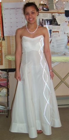 White taffeta gown , pearl trim
