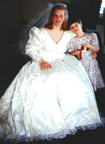 Ivory bridal gown with all over lace..Flower girl has a simple cotton dress
